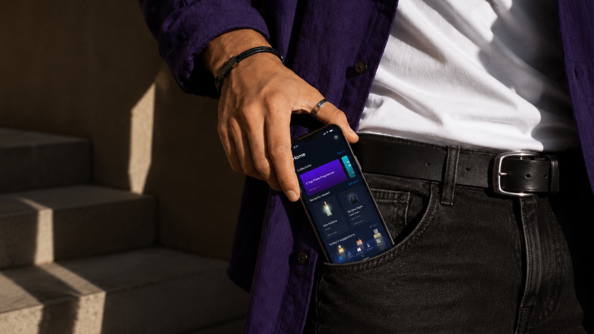 A man taking his phone from his pocket showing the MaxManScents fragrance collection tracker